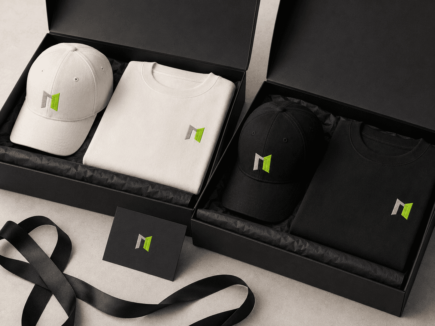 Premium apparel gift boxes with folded company T-shirts and embroidered caps