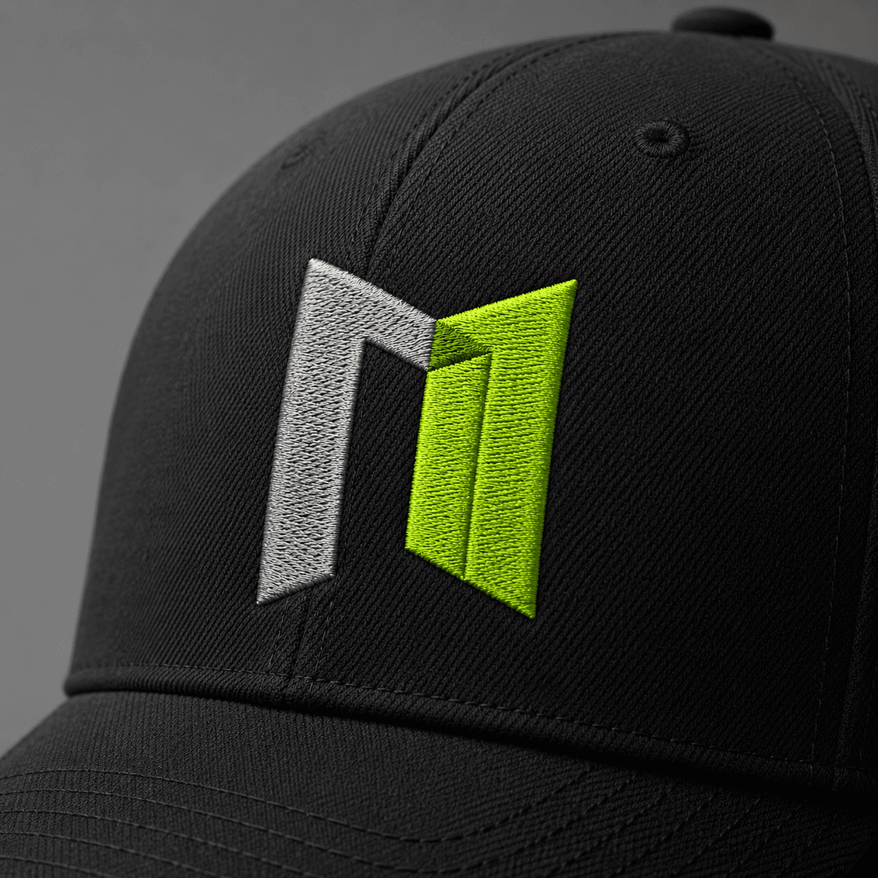 Macro detail of raised embroidery on a black custom company cap