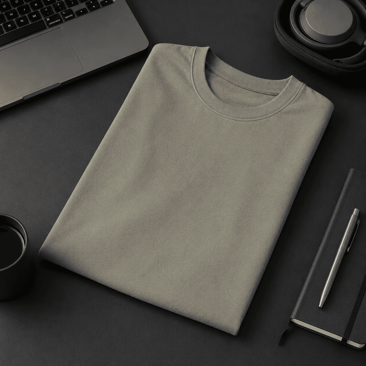Folded sage green custom company T-shirt on a desk showing finished quality.