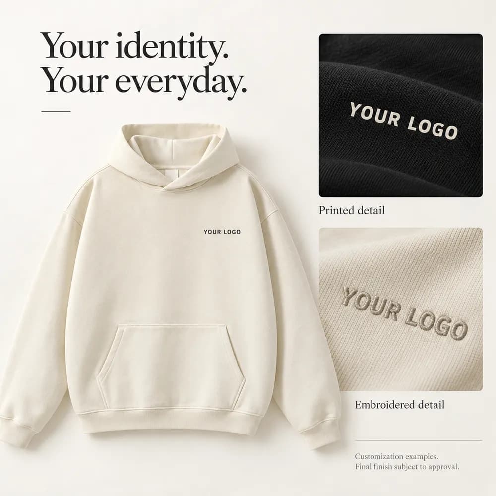 Ivory hoodie with YOUR LOGO placeholder and illustrative printed and embroidered finishes