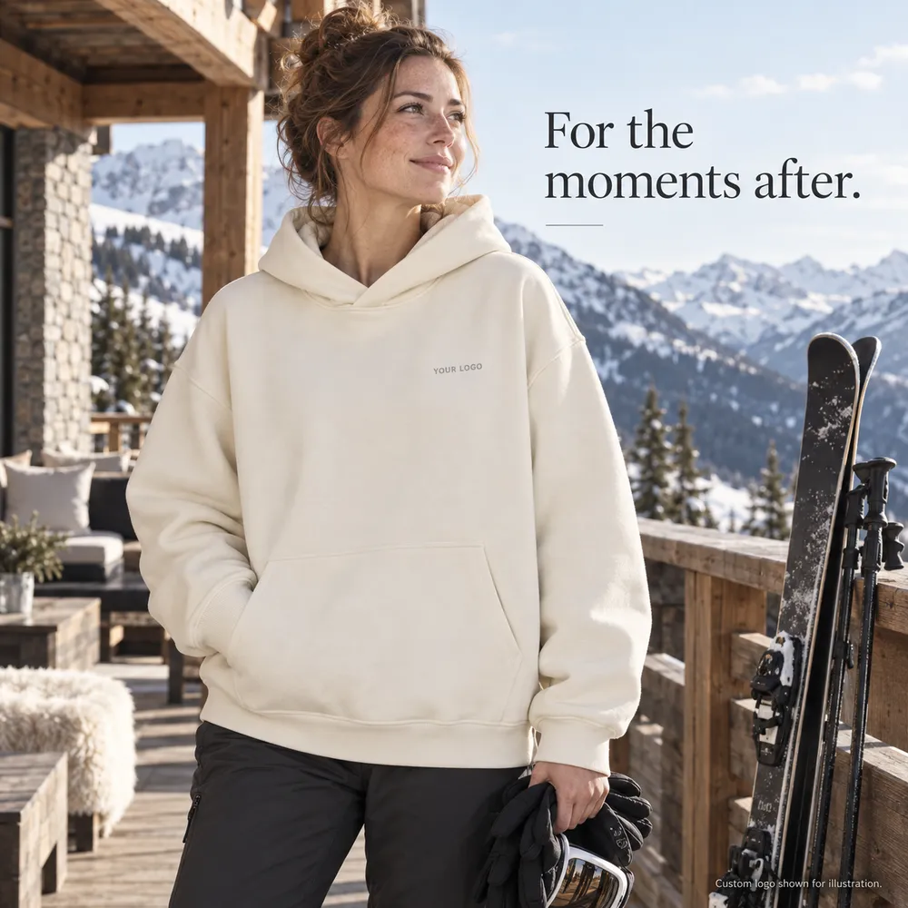 Adult woman in an ivory hoodie resting on a ski lodge terrace